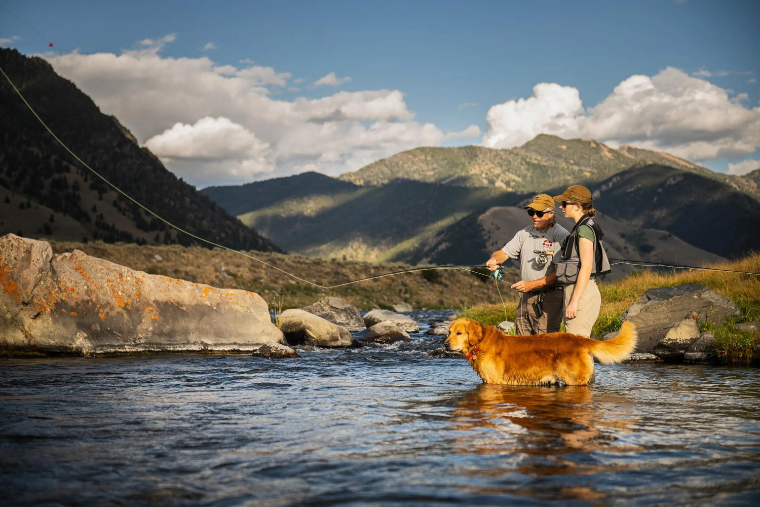 Fly Fisherman Teaching Fly Fishing Techniques to Daughter