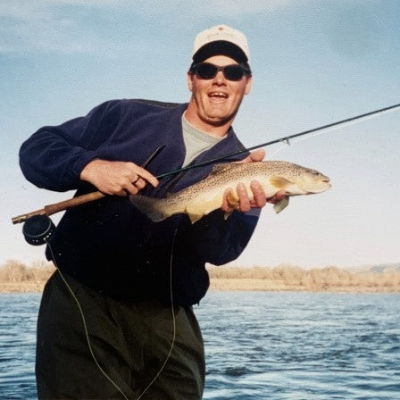 Fly Fisherman Posing with Fly Rod and Trout