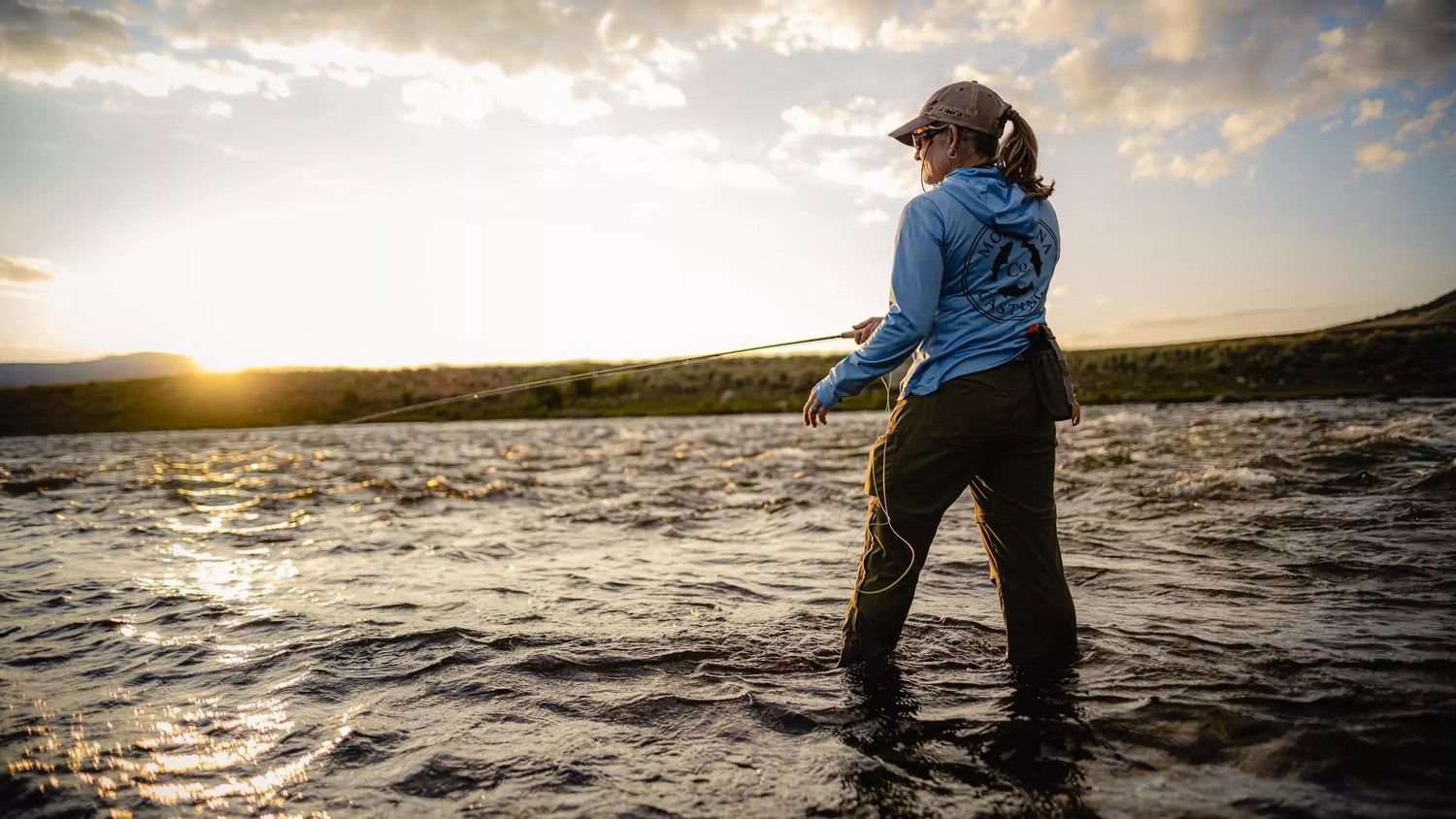 Woman Fly Fishing at Sunset