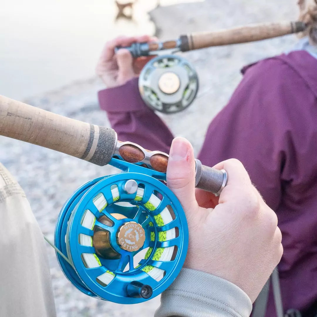 Two Women Carrying Fly Fishing Rods and Reels