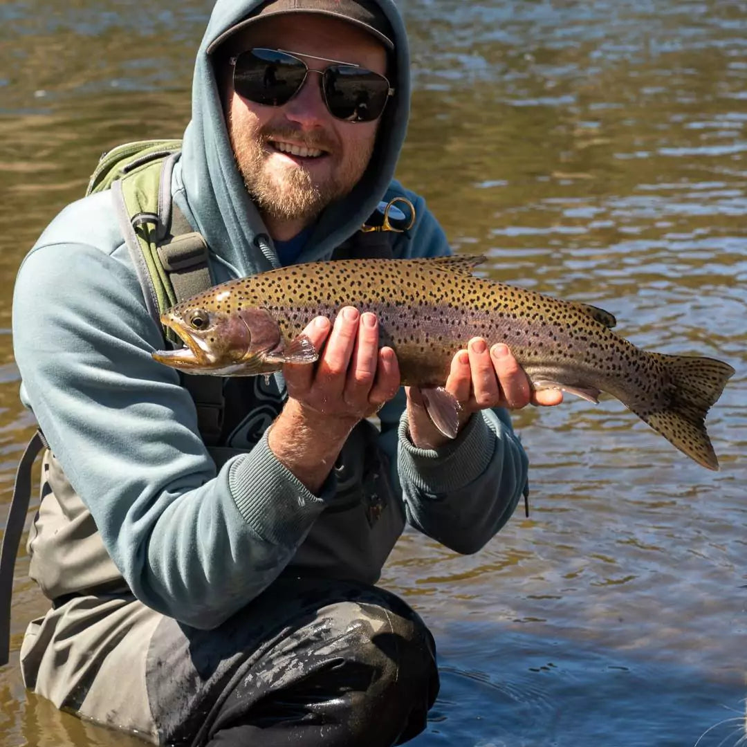 Fly Fishing Photographer Holding Up Trout