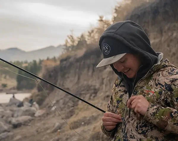 Fly Fisherman Rigging His Fly Rod on the River