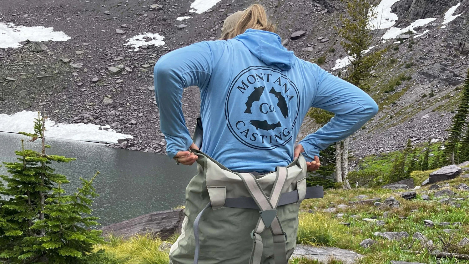 Woman Getting Into Fly Fishing Waders