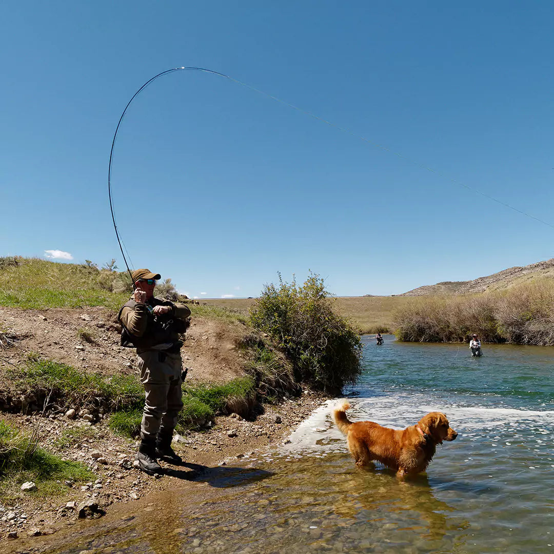 Man with Dog Fishing with a Fly Fishing Rod