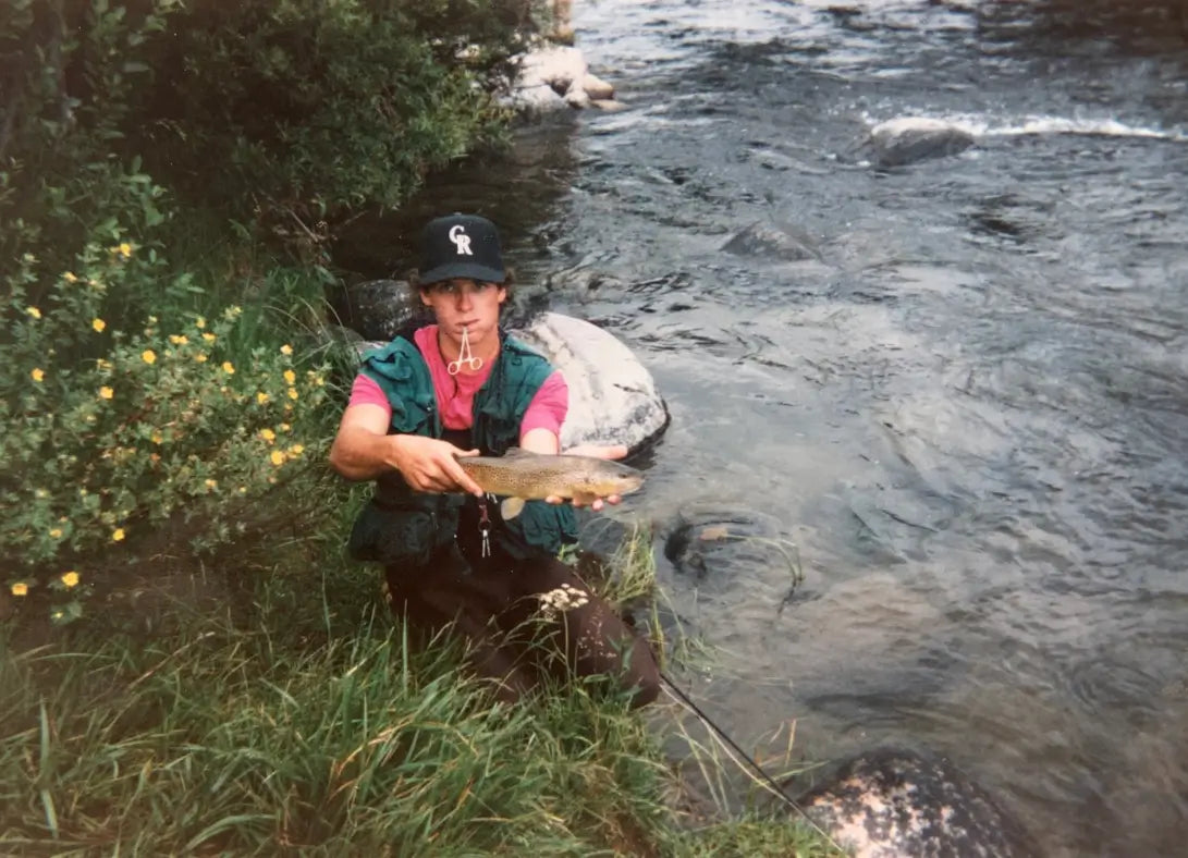 A Successful Fly Fisherman Holds Up a Trout